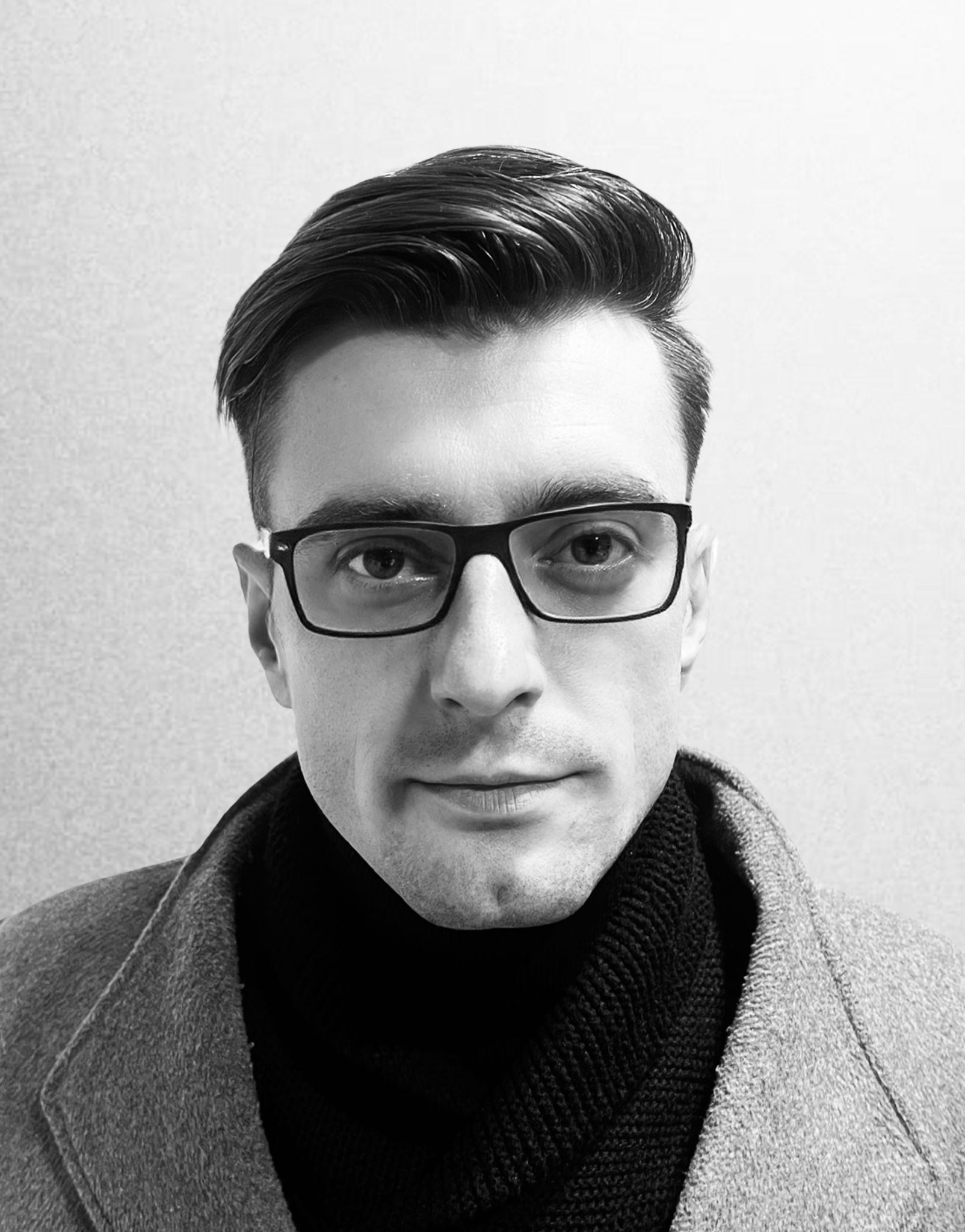 Tarik Abaspahic smiling and looking at the camera in a head-and-shoulders portrait; casual shirt in a home office with a blurred laptop and bookshelf in the background; friendly confident and approachable tone